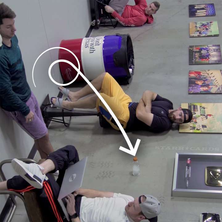 Dude Perfect's water bottle flip trick optical illusion shown right side up